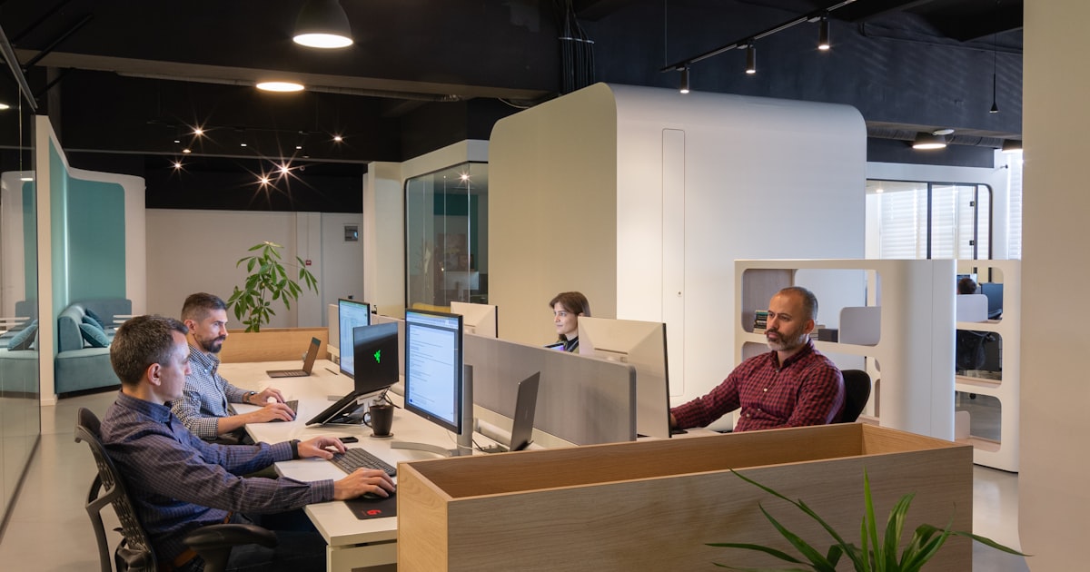 Professionals working at computers in a modern office