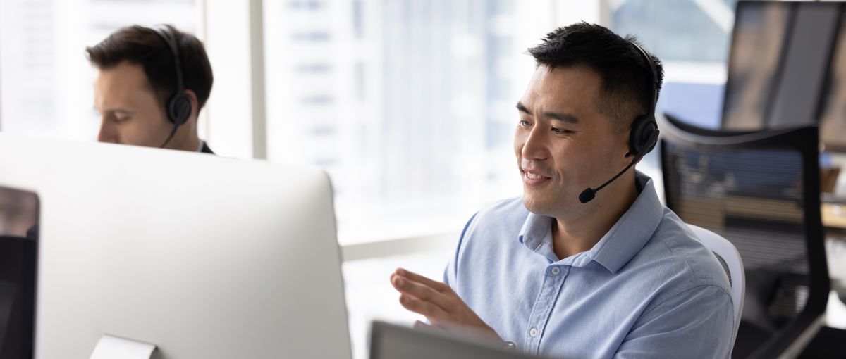 IT support agent with headset at desk